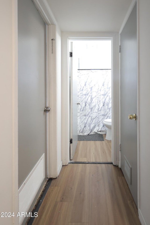 hall with hardwood / wood-style flooring