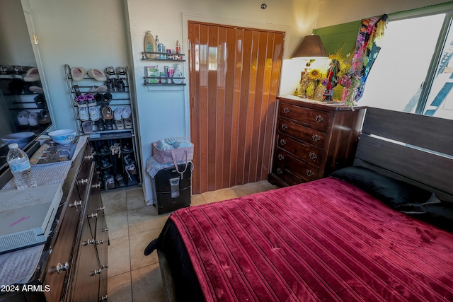 tiled bedroom featuring a closet