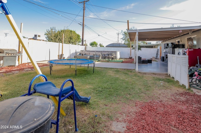 view of yard with a patio area and a trampoline