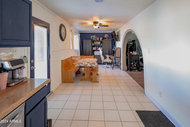 interior space featuring ornamental molding and light tile patterned floors