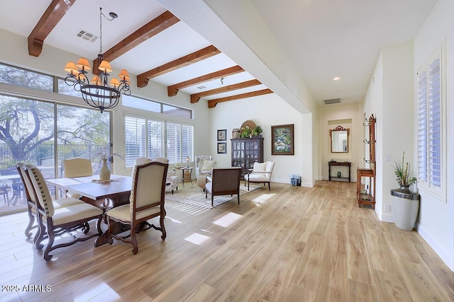 dining area with a healthy amount of sunlight, light hardwood / wood-style floors, and a notable chandelier