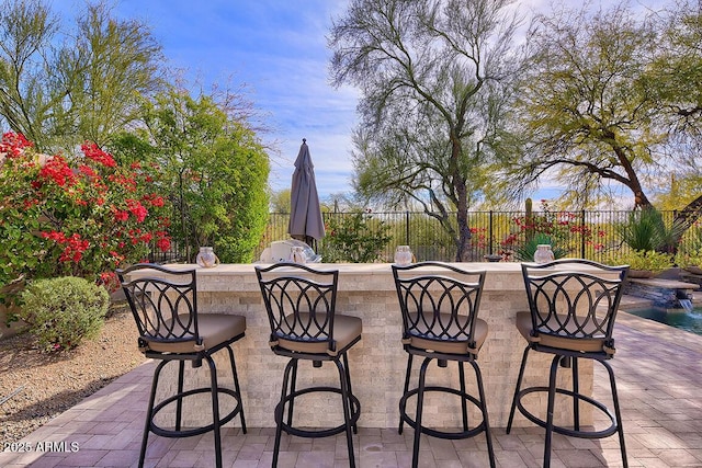 view of patio / terrace with exterior kitchen and a bar