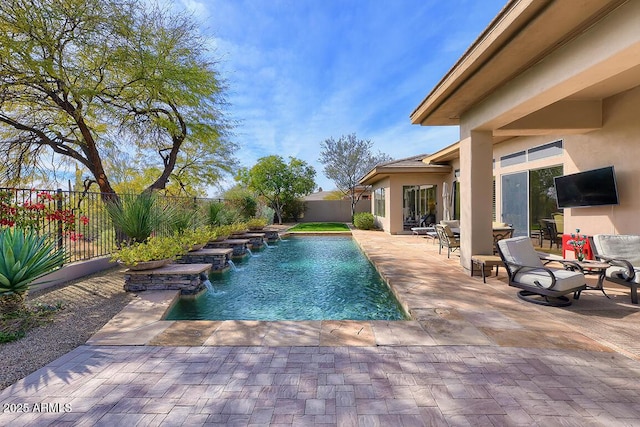 view of swimming pool with pool water feature and a patio area