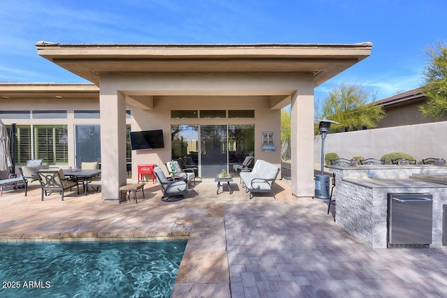 view of patio featuring a fenced in pool and exterior bar