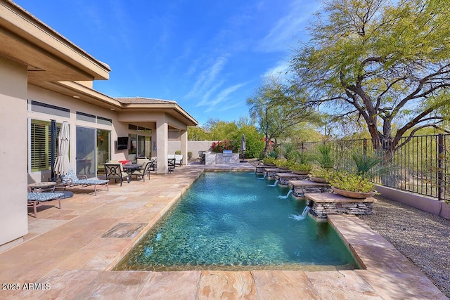 view of pool featuring pool water feature and a patio