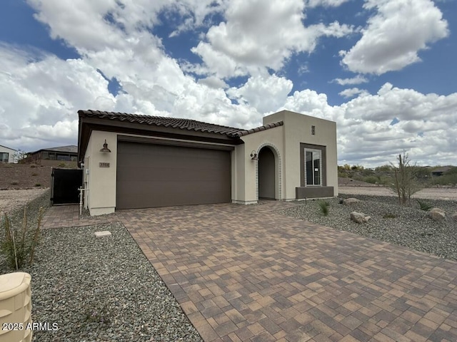 3584 Turquoise Trl, Wickenburg, AZ 85390 - view of front of house with stucco siding, decorative driveway, an attached garage, and a tiled roof
