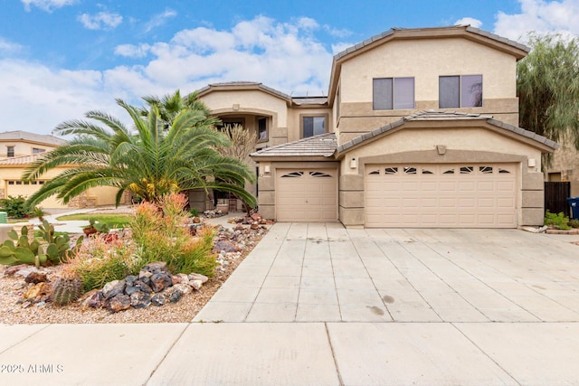 view of front of home featuring solar panels, concrete driveway, a garage, and stucco siding