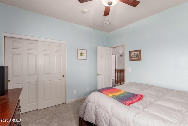 bedroom with visible vents, a closet, ceiling fan, and carpet flooring