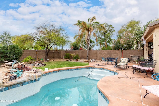 view of swimming pool featuring a fenced backyard and a patio area