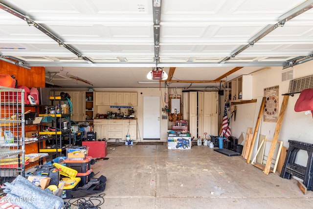 garage with a garage door opener and tankless water heater