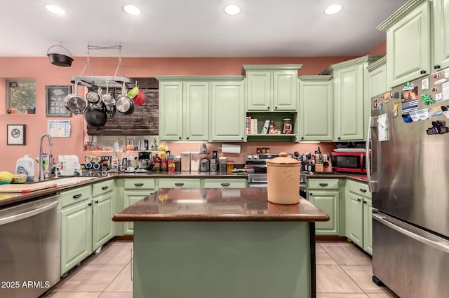 kitchen with green cabinets, recessed lighting, appliances with stainless steel finishes, and a kitchen island