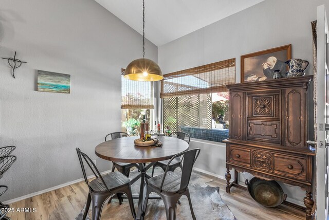 19930 N 98th Ave, Peoria, AZ 85382 - dining room featuring light wood finished floors, high vaulted ceiling, and baseboards