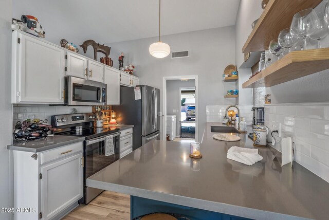 19930 N 98th Ave, Peoria, AZ 85382 - kitchen featuring appliances with stainless steel finishes, a sink, decorative backsplash, and open shelves