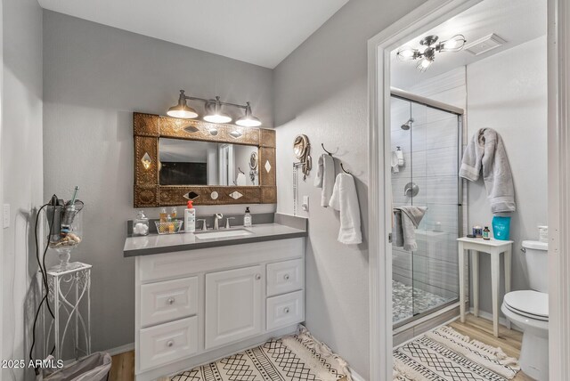 19930 N 98th Ave, Peoria, AZ 85382 - full bath with toilet, a stall shower, vanity, and wood finished floors