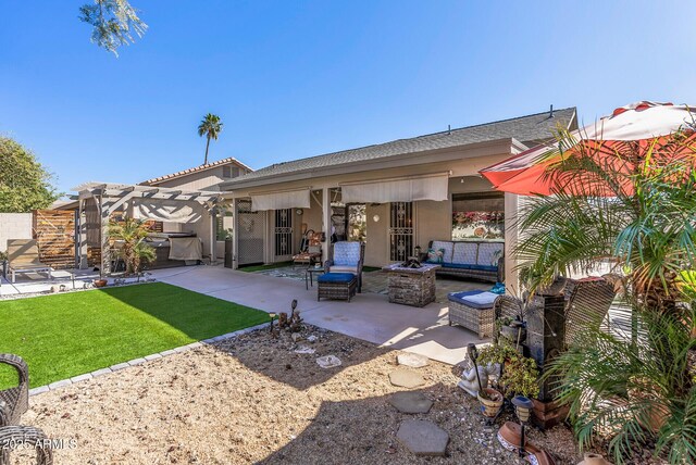 19930 N 98th Ave, Peoria, AZ 85382 - rear view of property featuring stucco siding, a patio, a yard, a pergola, and an outdoor living space with a fire pit