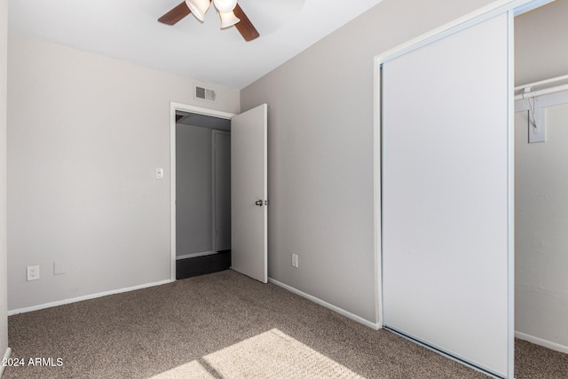 unfurnished bedroom with carpet, a closet, and ceiling fan