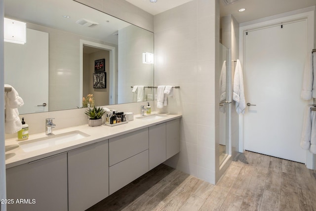 15215 N Kierland Blvd Unit 101, Scottsdale, AZ 85254 - full bathroom with double vanity, wood finished floors, and tile walls