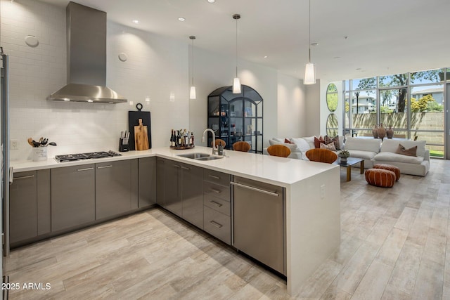 15215 N Kierland Blvd Unit 101, Scottsdale, AZ 85254 - kitchen featuring wall chimney range hood, stainless steel gas cooktop, open floor plan, gray cabinetry, and a wall of windows