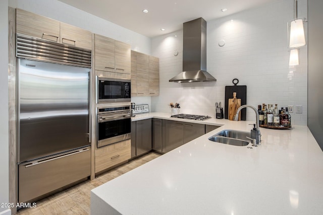 15215 N Kierland Blvd Unit 101, Scottsdale, AZ 85254 - kitchen featuring built in appliances, wall chimney exhaust hood, light wood-style flooring, light countertops, and decorative backsplash