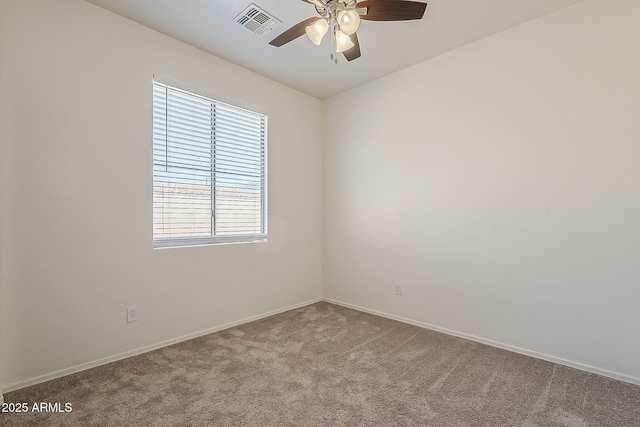 carpeted spare room with ceiling fan, visible vents, and baseboards