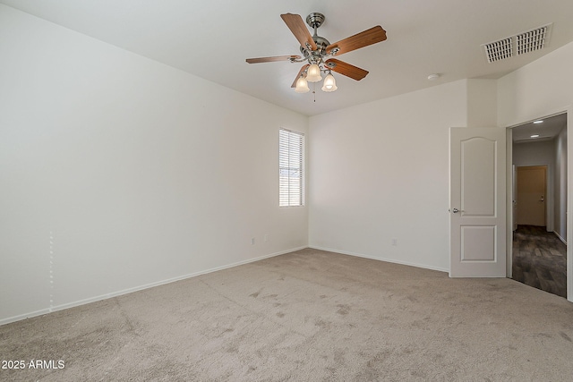 unfurnished room featuring a ceiling fan, carpet, visible vents, and baseboards