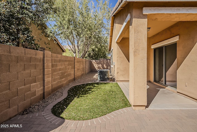 view of yard with central AC, a patio, and a fenced backyard