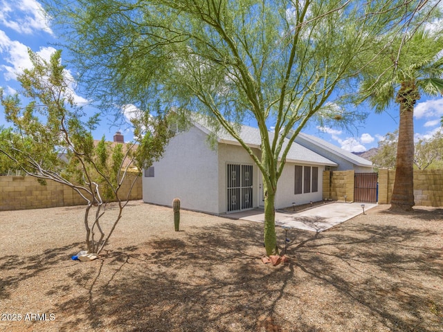 10613 S 41st Pl, Phoenix, AZ 85044 - back of property featuring a fenced backyard, a patio area, stucco siding, and a gate