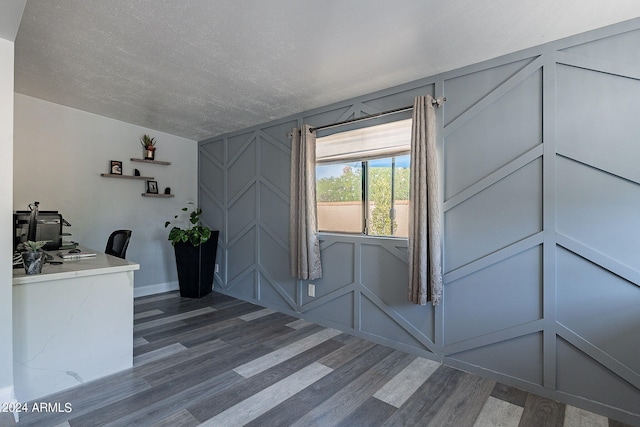 unfurnished office with wood-type flooring