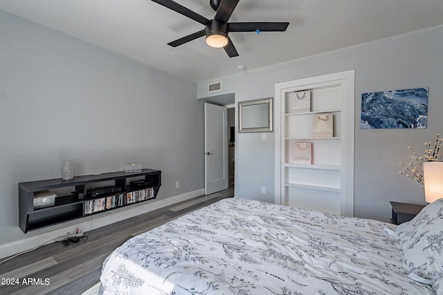 bedroom with ceiling fan and dark hardwood / wood-style flooring