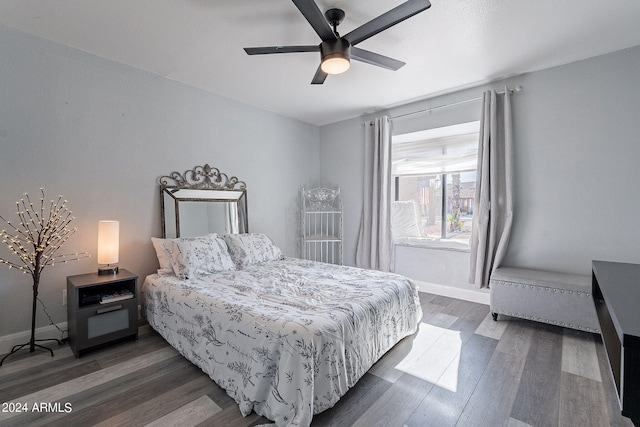 bedroom with ceiling fan and dark wood-type flooring