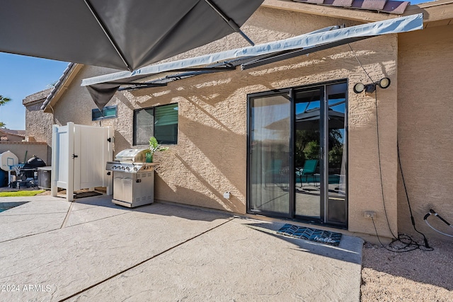 view of exterior entry featuring a patio area