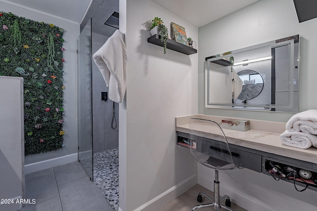 bathroom with tiled shower and tile patterned flooring