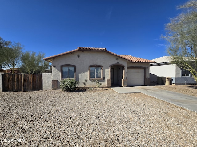 mediterranean / spanish home with a garage