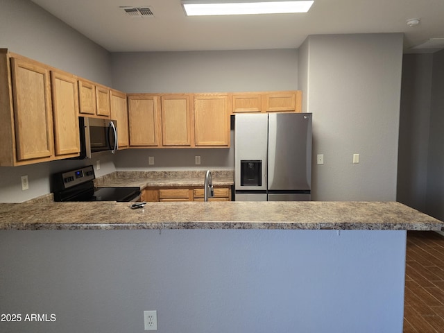 kitchen with stainless steel appliances, dark hardwood / wood-style floors, kitchen peninsula, and light brown cabinets