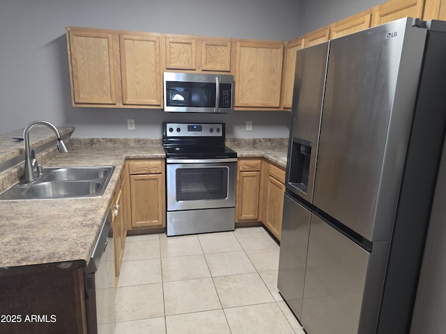 kitchen featuring stainless steel appliances, sink, and light tile patterned floors