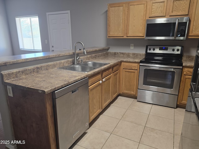 kitchen with stainless steel appliances, kitchen peninsula, sink, and light tile patterned floors