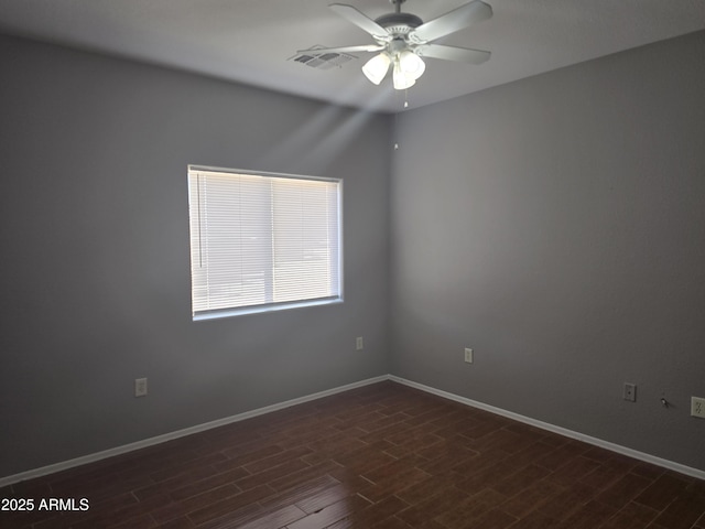 unfurnished room featuring dark wood-type flooring and ceiling fan