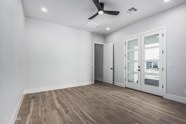 3653 E Runaway Bay Pl, Queen Creek, AZ 85142 - empty room with ceiling fan, wood finished floors, baseboards, french doors, and recessed lighting