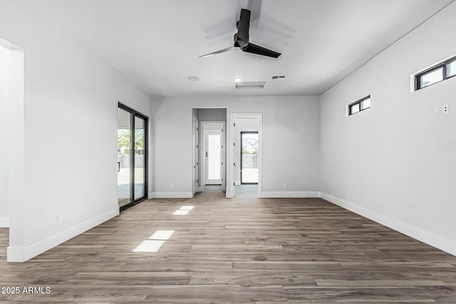 3653 E Runaway Bay Pl, Queen Creek, AZ 85142 - unfurnished room with a ceiling fan, wood finished floors, and baseboards