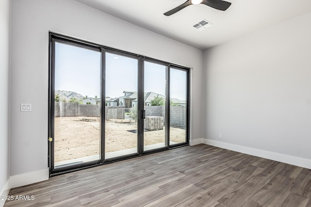 3653 E Runaway Bay Pl, Queen Creek, AZ 85142 - spare room with wood finished floors, baseboards, and ceiling fan