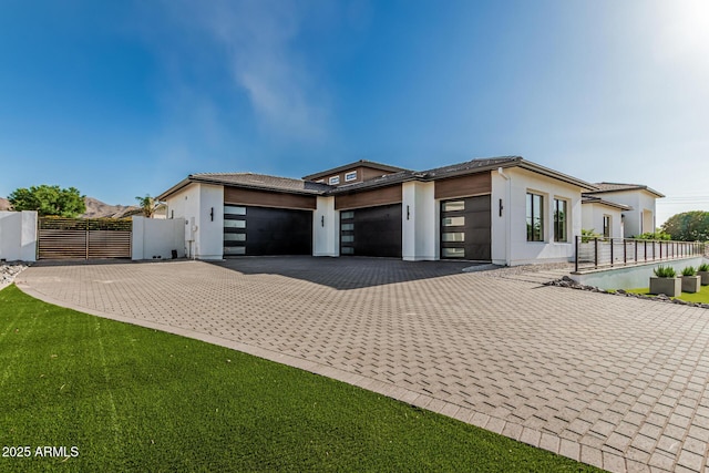 3653 E Runaway Bay Pl, Queen Creek, AZ 85142 - view of front of home with an attached garage, decorative driveway, stucco siding, and a gate
