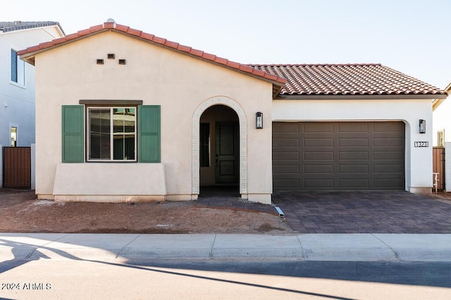 mediterranean / spanish home featuring a garage