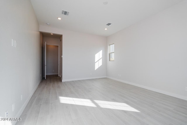 spare room with light hardwood / wood-style flooring