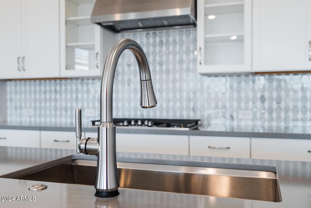 details featuring white cabinets and ventilation hood