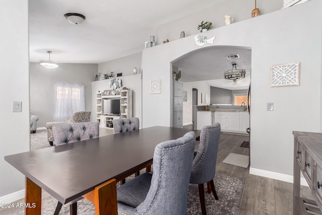 dining space with dark hardwood / wood-style floors and sink