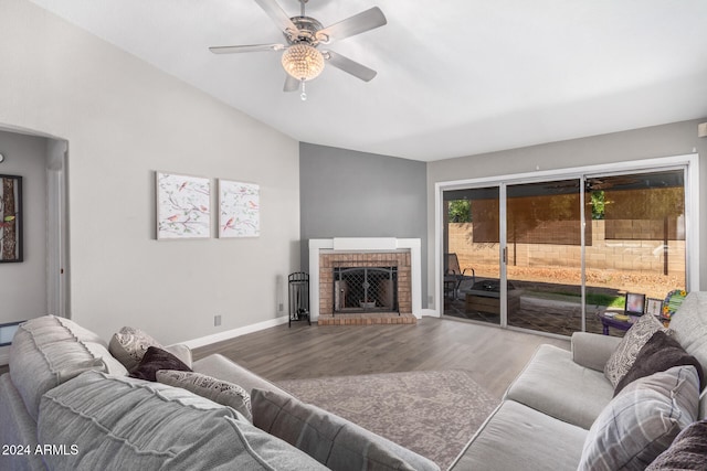 living room featuring a brick fireplace, ceiling fan, lofted ceiling, and hardwood / wood-style flooring