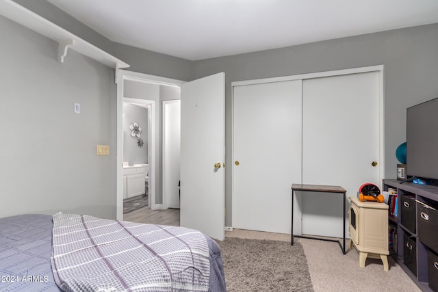 bedroom featuring a closet and light colored carpet