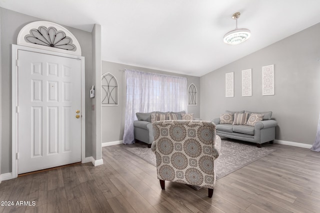 living room with hardwood / wood-style floors and vaulted ceiling