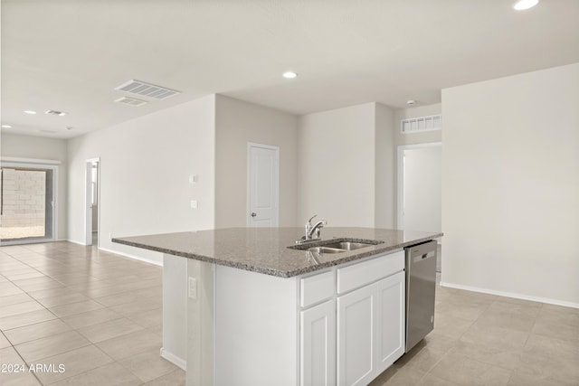kitchen with visible vents, baseboards, a sink, dark stone countertops, and dishwasher