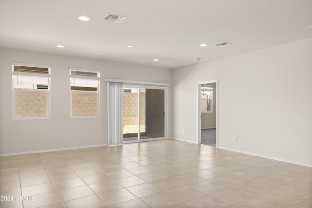 empty room with visible vents, recessed lighting, baseboards, and a healthy amount of sunlight